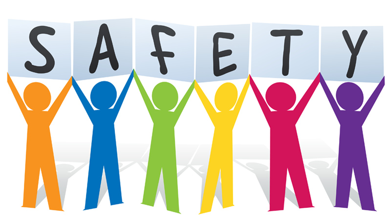 Color paper people cutout holding letters that spell SAFETY